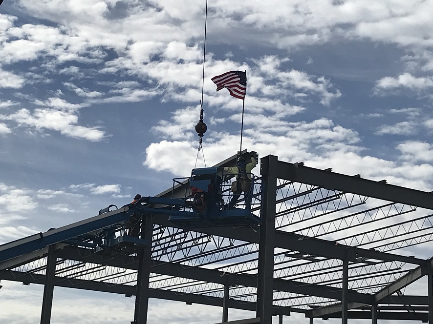 Man Putting American Flag on Beam