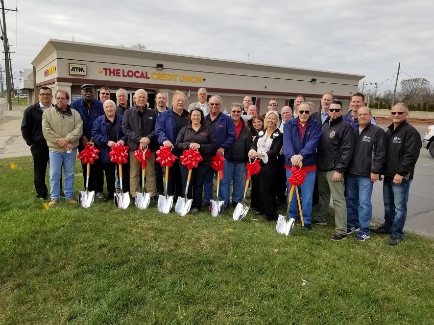 Bank Employees Holding Shovels